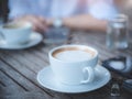 Cup of hot coffee , Key of car and smartphone in cafe.The concept of drinking coffee for leisure, travel and modern lifestyle Royalty Free Stock Photo