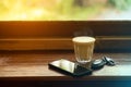 Cup of hot coffee , Key of car and smartphone in cafe.The concept of drinking coffee for leisure, travel and modern lifestyle Royalty Free Stock Photo