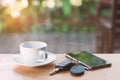 Cup of hot coffee , Key and smartphone in cafe Royalty Free Stock Photo