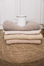 A cup of hot coffee with milk on a stack of knitted clothes. Autumn mood. The concept of home comfort