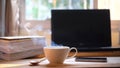 A cup of hot coffee smoke and a book, computer on wood table