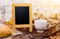 Cup of hot coffee with empty board in Autumn season Royalty Free Stock Photo