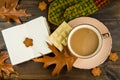 Cup of hot coffee White chocolate cookies with oak leaves with mitten notebook on wooden background Royalty Free Stock Photo