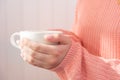 A Cup with a hot drink in the hands of a girl