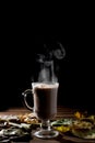 Cup of hot drink with steam over black background. Royalty Free Stock Photo