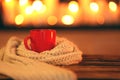 Cup of hot drink on wooden table against blurred background. Winter atmosphere Royalty Free Stock Photo