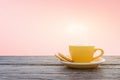 A cup of hot espresso coffee mugs placed with cookies on a wooden floor with pink background,coffee morning