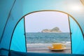 A cup of hot espresso coffee mugs placed on a wooden floor on sea inside view tent with sunlight background,coffee morning