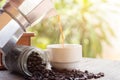 A cup of hot espresso coffee mugs and roasted coffee beans with moka pot placed on wooden floor background,coffee morning, Royalty Free Stock Photo