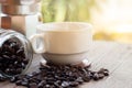 A cup of hot espresso coffee mugs and roasted coffee beans with moka pot placed on wooden floor background,coffee morning, Royalty Free Stock Photo