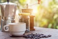 A cup of hot espresso coffee mugs and roasted coffee beans with moka pot placed on wooden floor background,coffee morning, Royalty Free Stock Photo