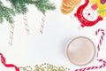 A cup of hot flavored cocoa or chocolate, cookies, marmalade on a white background, Christmas decorations. Top view. Copy space