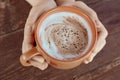 A cup of hot flavored cocoa in the hands. Close-up photo. Beautiful milk froth Royalty Free Stock Photo