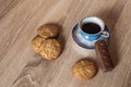 A cup of hot fragrant black coffee in a saucer with cookies and a chocolate bar Royalty Free Stock Photo