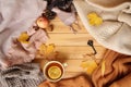 Cup of hot fragrant tea with lemon, autumn leaves, apple, cozy scarves and knitted sweaters, key, flat, concept of hugg, winter or