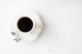 A cup of hot fresh black coffee with foam on a white background. Coffee cup on a round saucer centered inside the frame. Top view Royalty Free Stock Photo