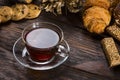 A cup of hot herbal tea and cookies on the old wooden background Royalty Free Stock Photo