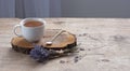 A cup of hot herbal tea and lavender on an old wooden background. Royalty Free Stock Photo