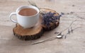 A cup of hot herbal tea and lavender on an old wooden background. Royalty Free Stock Photo