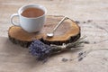 A cup of hot herbal tea and lavender on an old wooden background. Royalty Free Stock Photo