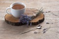 A cup of hot herbal tea and lavender on an old wooden background. Royalty Free Stock Photo