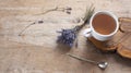 A cup of hot herbal tea and lavender on an old wooden background. Royalty Free Stock Photo