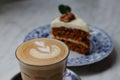 Cup of hot latte coffee with carrot cake as dessert with selective focus for cafe design purpose Royalty Free Stock Photo