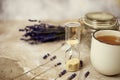 Cup of hot lavender tea. Herbal tea hot drink with sand glass timer.. Royalty Free Stock Photo