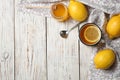 Cup with hot lemon tea and honey on wooden background, top view Royalty Free Stock Photo