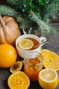 Cup of hot lemon tea with orange pumpkin and ginger jam on a wooden background. Healthy drink cold. Winter drink Royalty Free Stock Photo