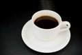 Cup with hot liquid and steam on black Royalty Free Stock Photo