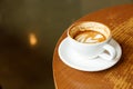 Cup of hot milk latte coffee on table by the window Royalty Free Stock Photo