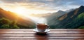 A cup of hot morning coffee with steam on a wooden table against a background of sunrise scene in the mountains. Royalty Free Stock Photo