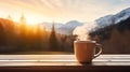 A cup of hot morning coffee with steam on a wooden table against a beautiful background of sunrise scene in the mountains Royalty Free Stock Photo