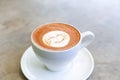 Cup of hot tasty cappucino with smile as art latte Royalty Free Stock Photo