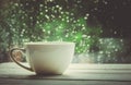 A cup of hot tea in the background rain outside the window. Royalty Free Stock Photo
