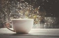 A cup of hot tea in the background rain outside the window. Royalty Free Stock Photo