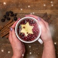 Cup of Hot Tea with Berry and Apple Cinnamon Spices Wooden background Christmas Food Concept Top View Female Hands Holding Cup of Royalty Free Stock Photo