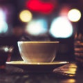 Cup of a hot tea in cafe. Anamorphic bokeh effect. Tilt-shift photo. Tasty aromatic tea in a lovely cup with a saucer