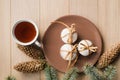 A cup of hot tea with Christmas gingerbread, a branch of a spruce tree on a wooden background Royalty Free Stock Photo