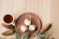 A cup of hot tea with Christmas gingerbread, a branch of a spruce tree on a wooden background Royalty Free Stock Photo