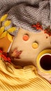 Cup of hot tea or coffee, autumn flat in hugg style, with yellow leaves, cozy knitwear, candles and berries, blank for designer, Royalty Free Stock Photo