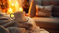 Cup of hot tea or coffee and knitted warm blanket. Cozy hygge atmosphere at home. Christmas time with candles. Selective focus, Royalty Free Stock Photo