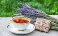 Cup of hot tea, fragrant lavender and gift. Summer tea in the garden. Royalty Free Stock Photo