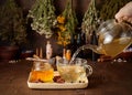 Cup of hot tea with honey, spices and drying medical herbs for use in alternative medicine Royalty Free Stock Photo