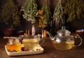 Cup of hot tea with honey, spices and drying medical herbs for use in alternative medicine Royalty Free Stock Photo