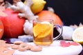 A cup of hot tea with lemon on an autumn background. Glass transparent cup with a drink Royalty Free Stock Photo