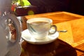A cup of hot tea with milk on mug, put on wooden table and bright light  from sun in afternonn, Traditional english tea. Royalty Free Stock Photo