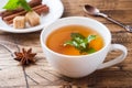 Cup of hot tea with mint and brown sugar on a wooden table Royalty Free Stock Photo