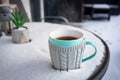 A cup of hot tea on the snowy garden terrace at winter Royalty Free Stock Photo